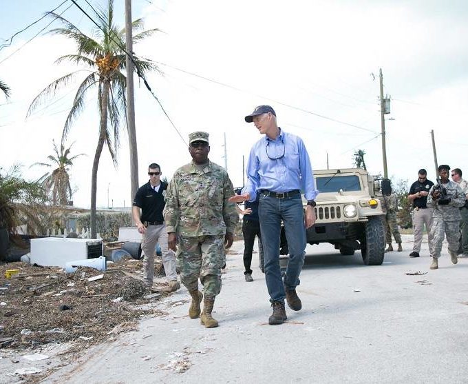 A solider and Governor Rick Scott walking though Key West.